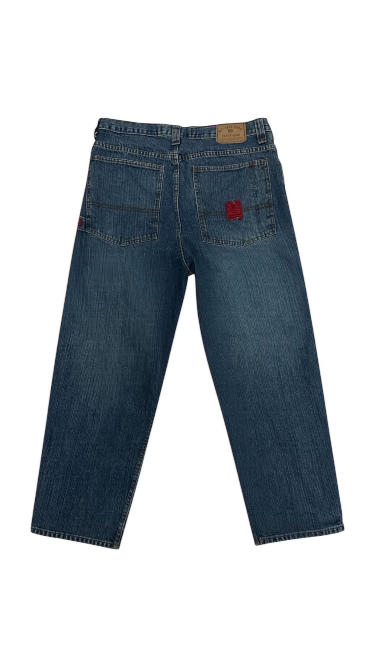 SohoStich Co. mid-wash denim jeans with relaxed fit and red accent patch on back pocket.