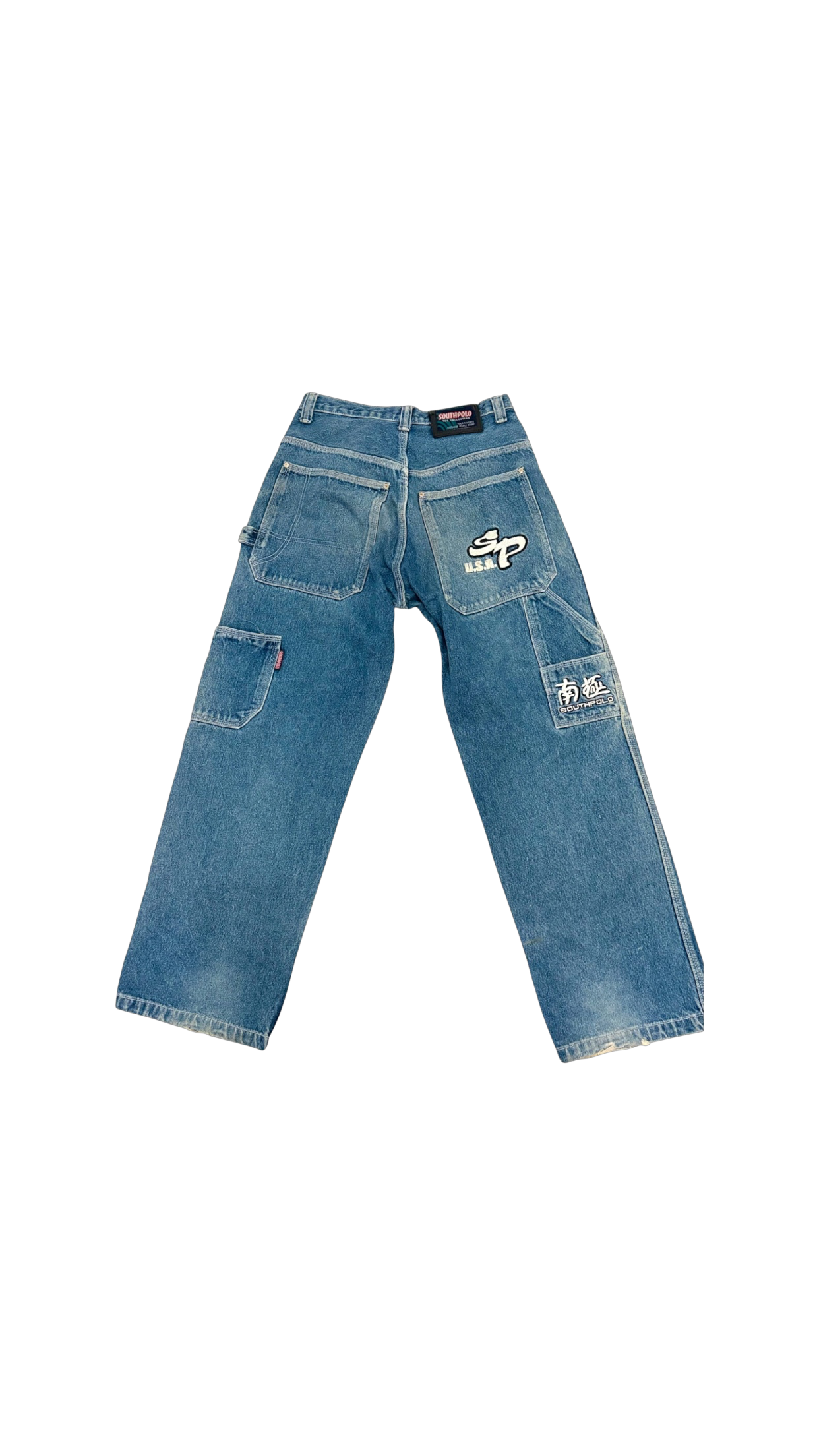 SohoStich Co. blue denim baggy carpenter jeans with embroidered logos and cargo pocket details.