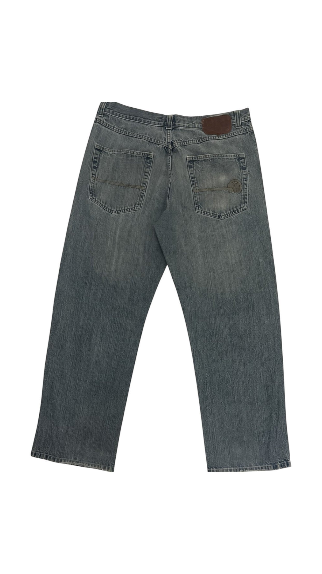 SohoStich Co. classic blue denim jeans with five-pocket styling and a branded leather patch.