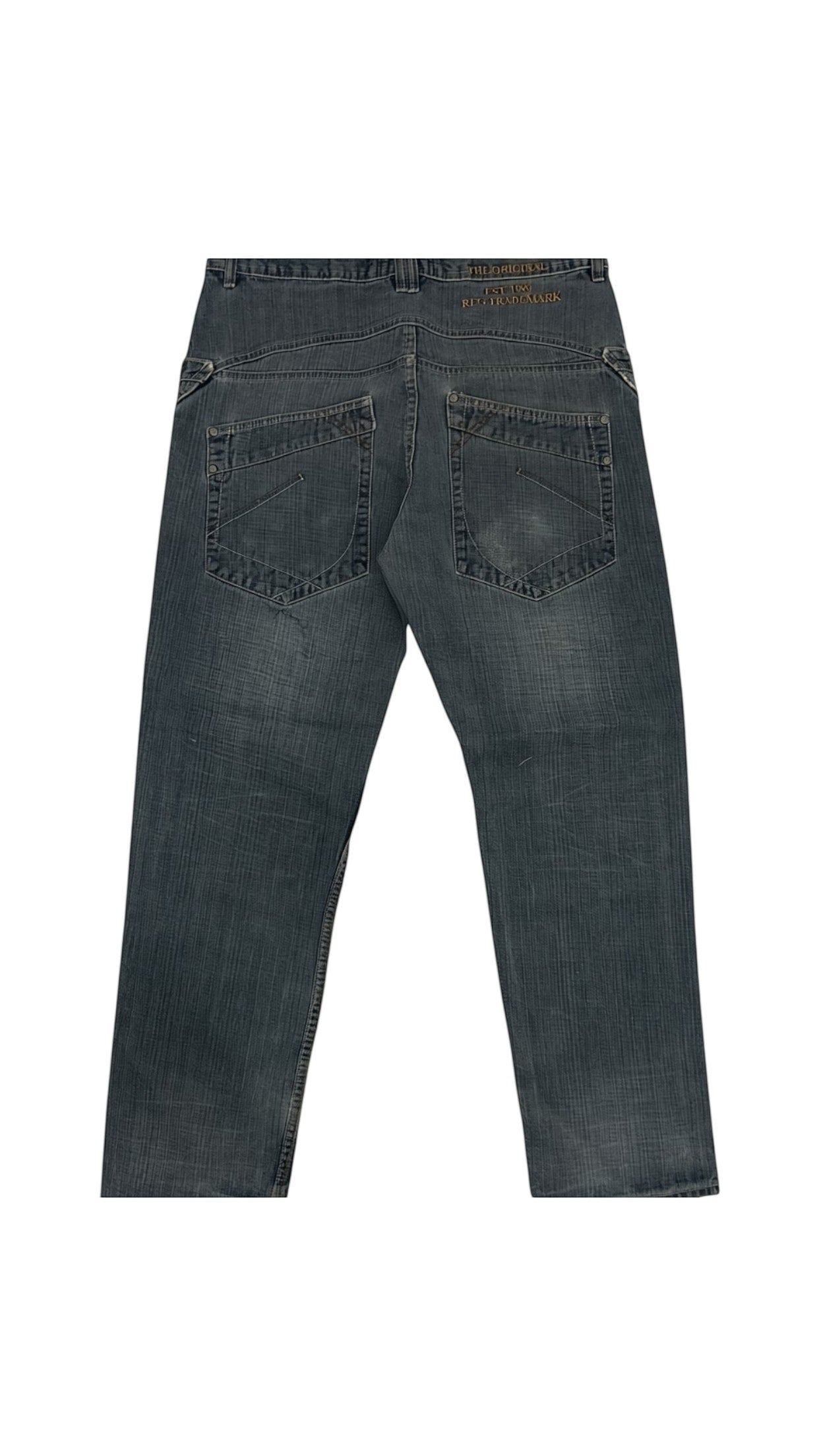SohoStich Co. dark wash denim jeans with stitch detail on back pockets. Relaxed fit, cotton denim.