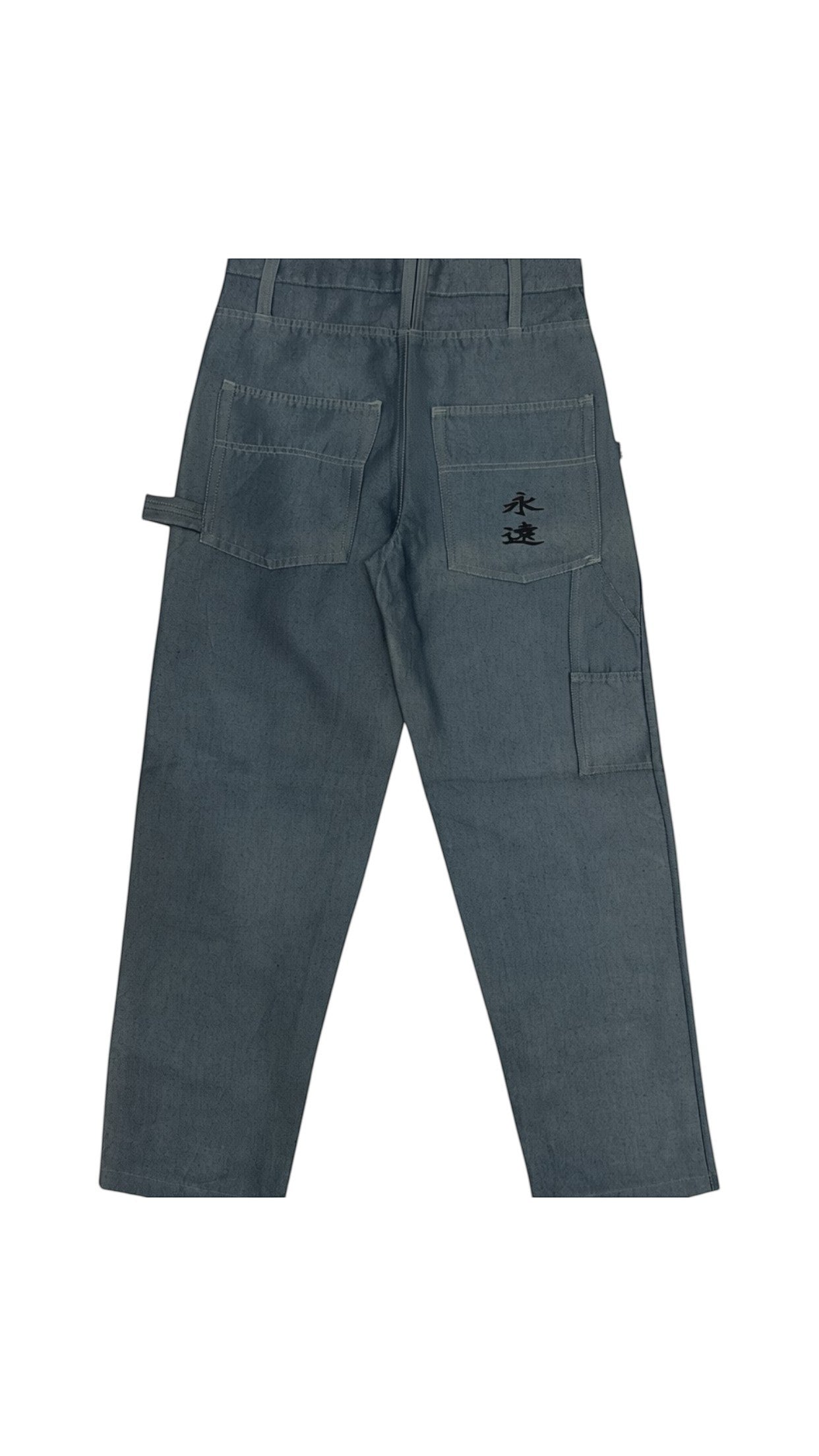 SohoStich Co. mid-wash denim carpenter pants with hammer loop and embroidered detail on back pocket.