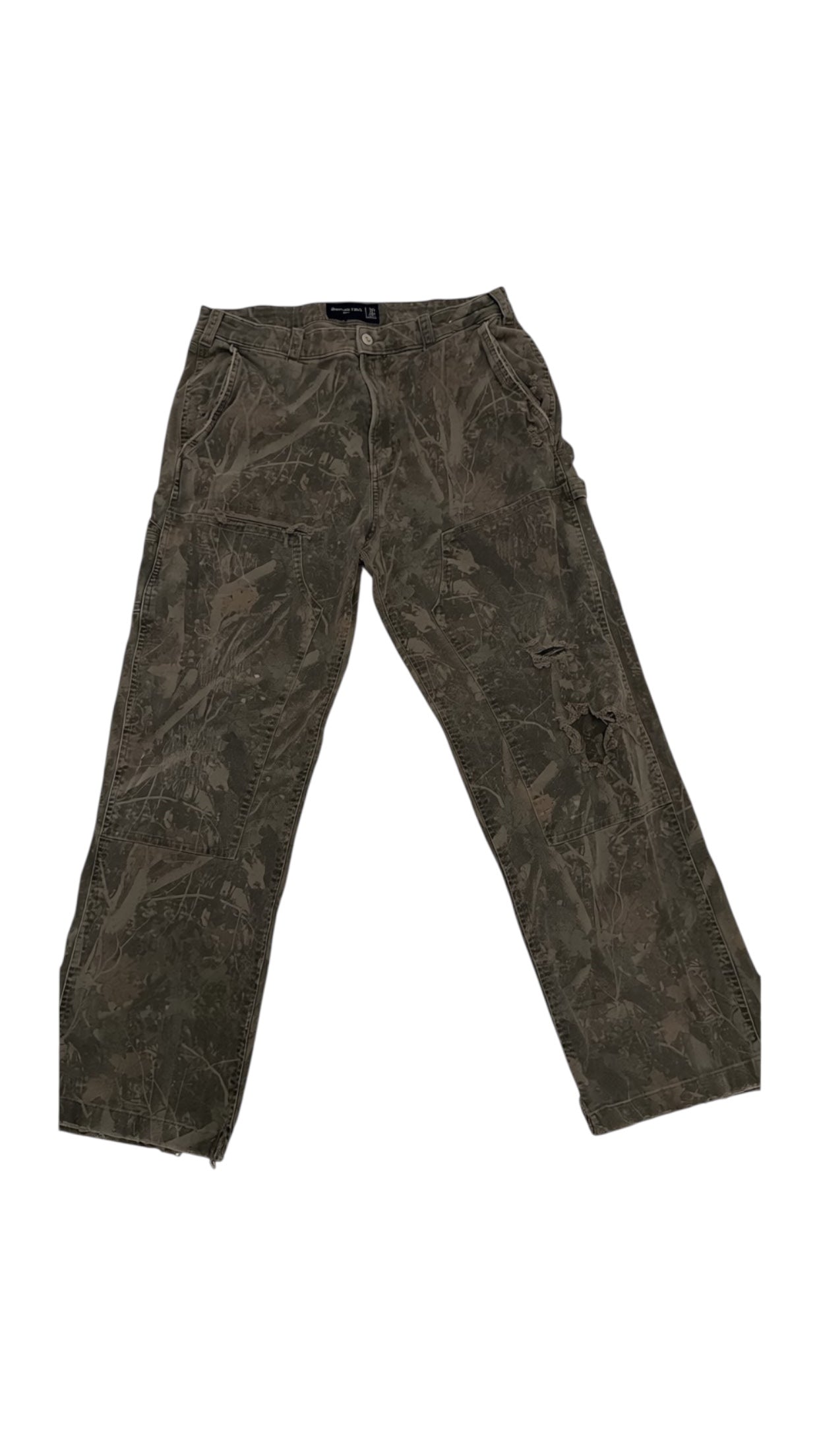 SohoStich Co. distressed camouflage cargo pants in earthy tones, cotton blend, relaxed fit, multiple pockets.