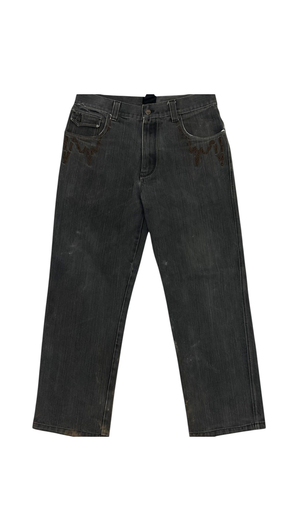 SohoStich Co. dark wash denim jeans with embroidered eagle motifs on back pockets and studded brown trim.