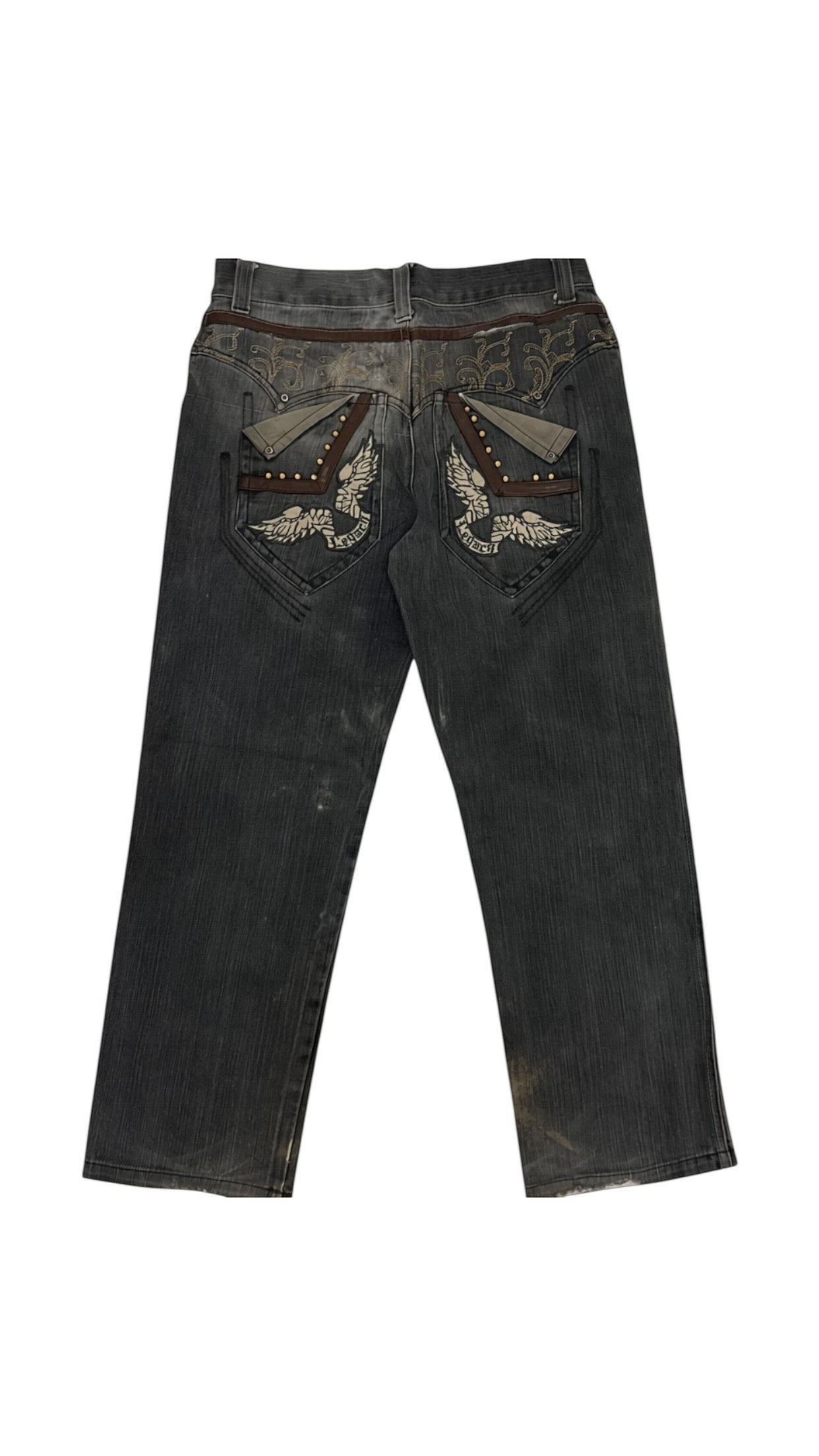 SohoStich Co. dark wash denim jeans with embroidered eagle pocket details and studded brown trim.