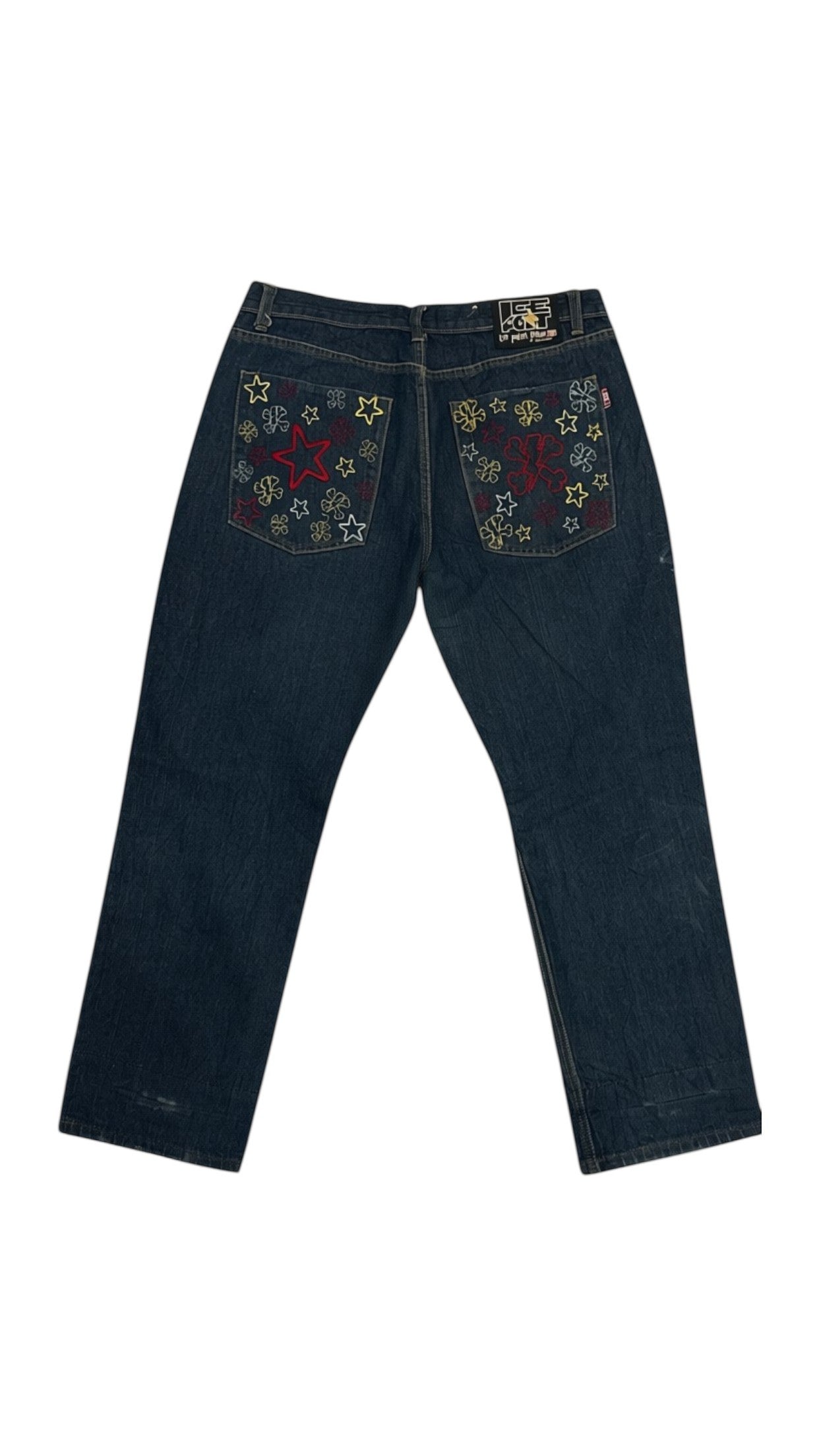 SohoStich Co. dark wash denim jeans with embroidered red and yellow stars and floral details on back pockets.