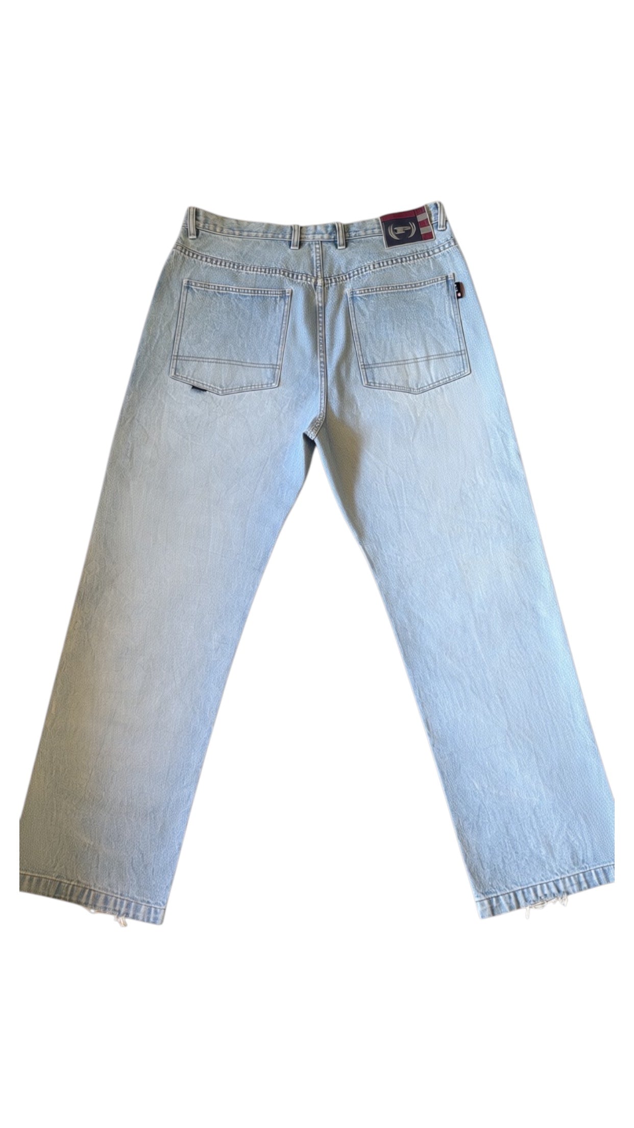 SohoStich Co. light wash relaxed fit denim jeans with a baggy silhouette and distressed hem.