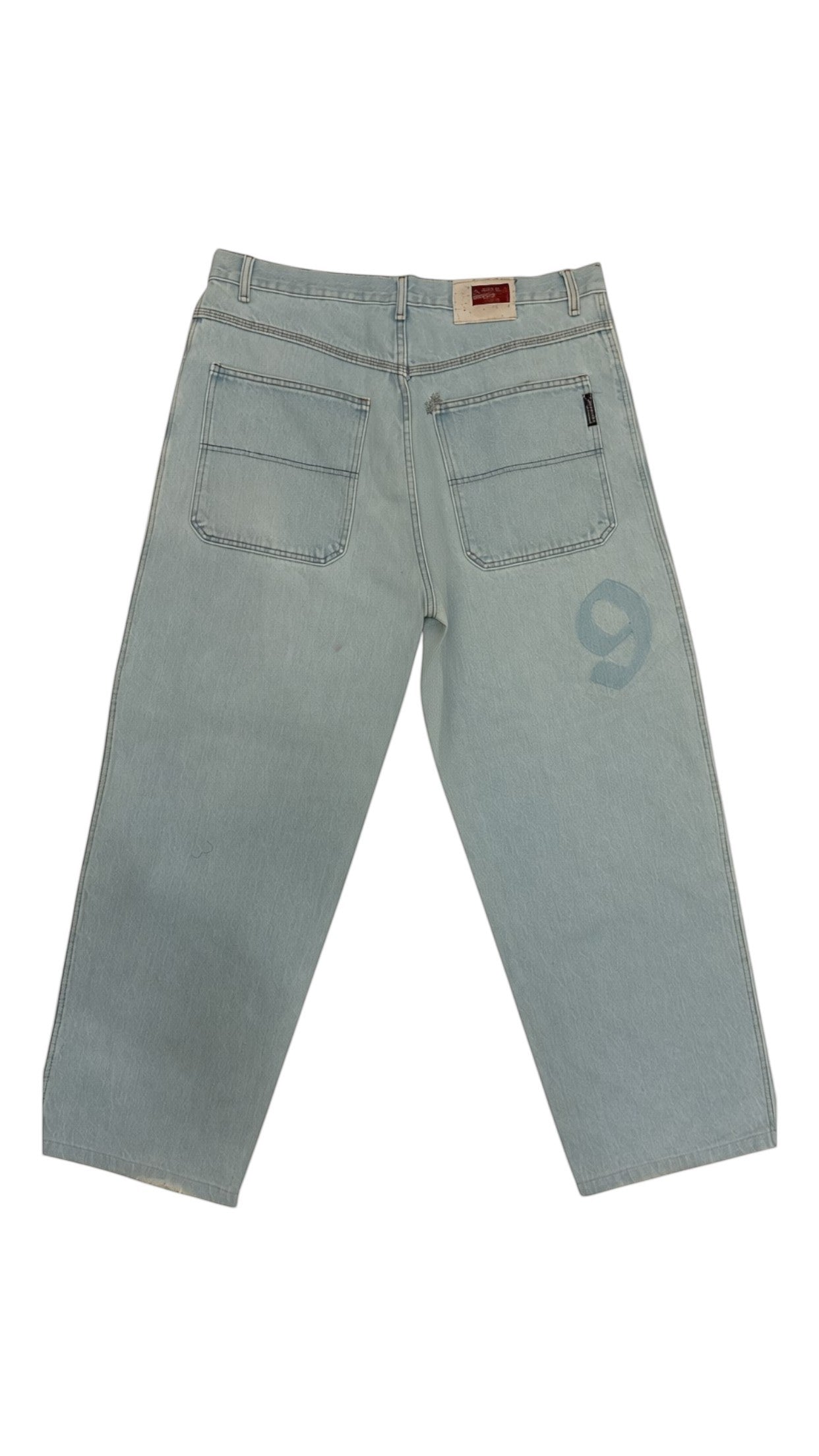 SohoStich Co. light wash denim jeans with embroidered logo on thigh and five-pocket style.