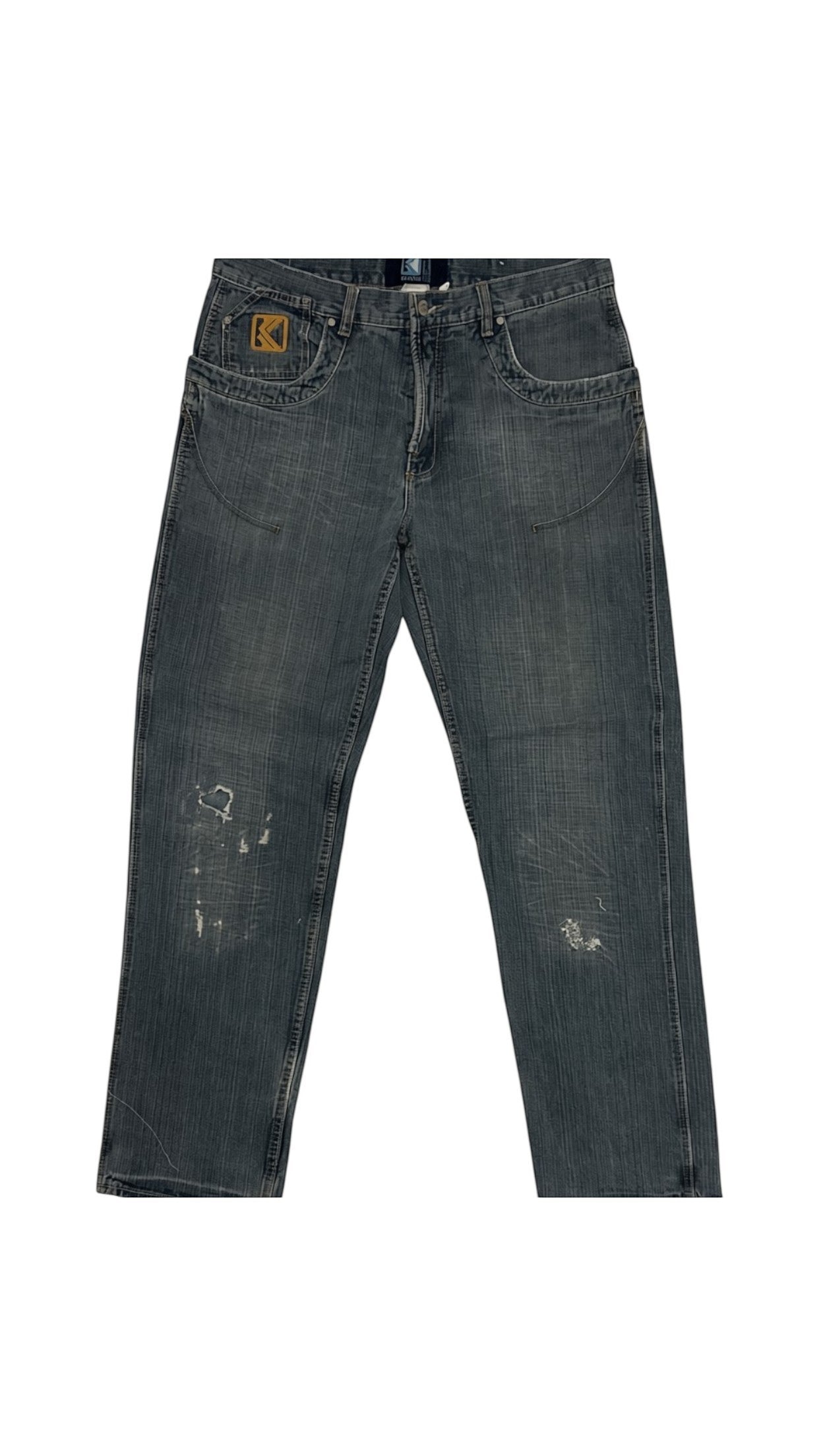 SohoStich Co. Men's dark wash denim jeans with relaxed fit and distressed details on back pockets.
