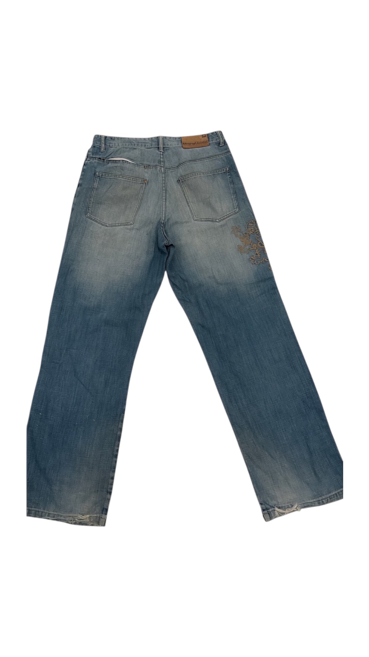 SohoStich Co. Men's relaxed fit medium wash denim jeans with embroidered graphic detail on left leg and whiskering.