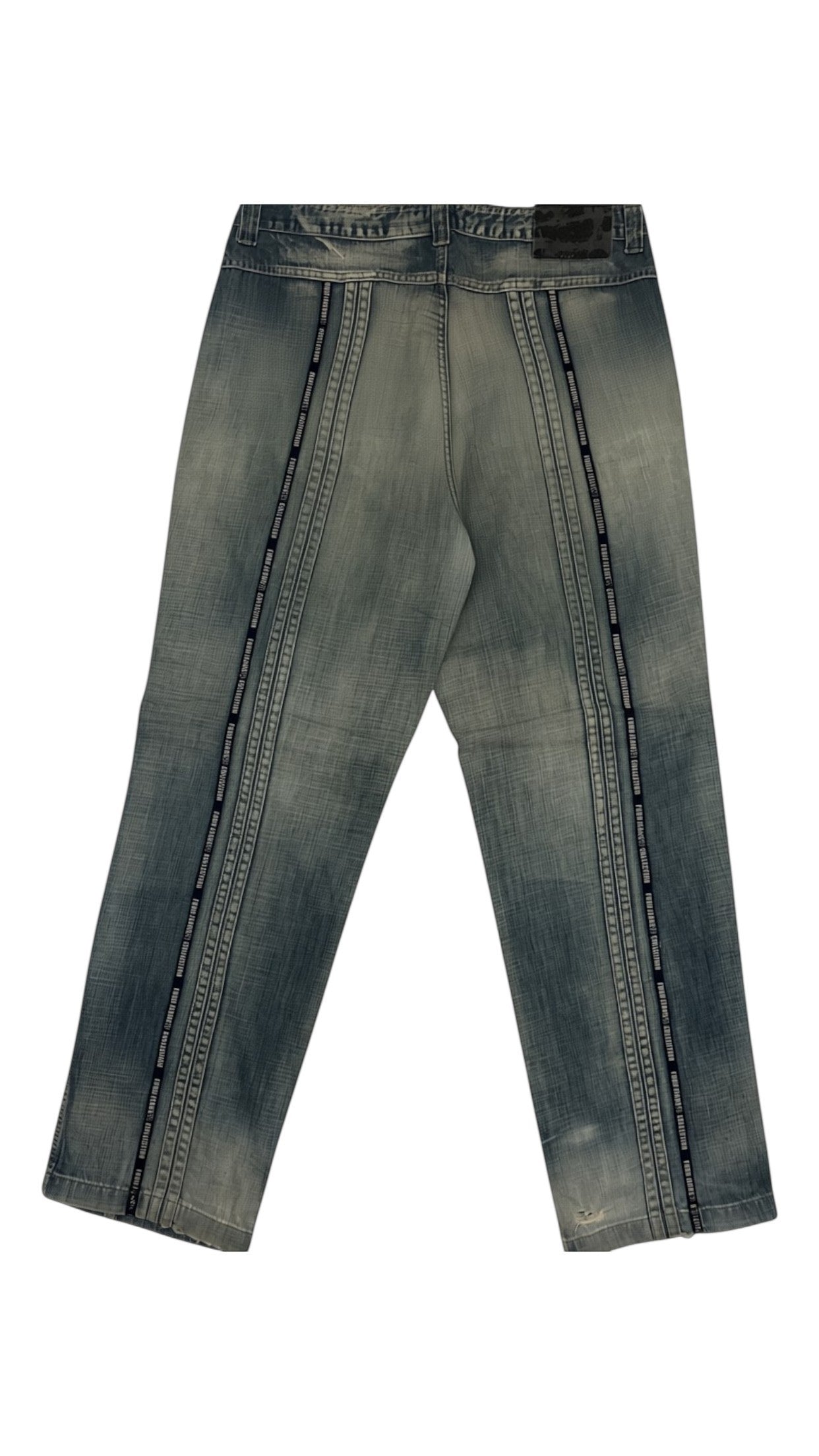 SohoStich Co. light-wash denim jeans with relaxed fit, vertical seams, and distressed thigh patch.